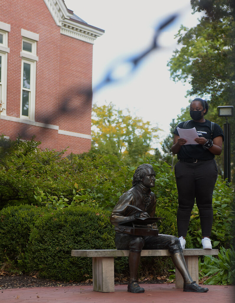A student protester leads out a list of demands on Friday